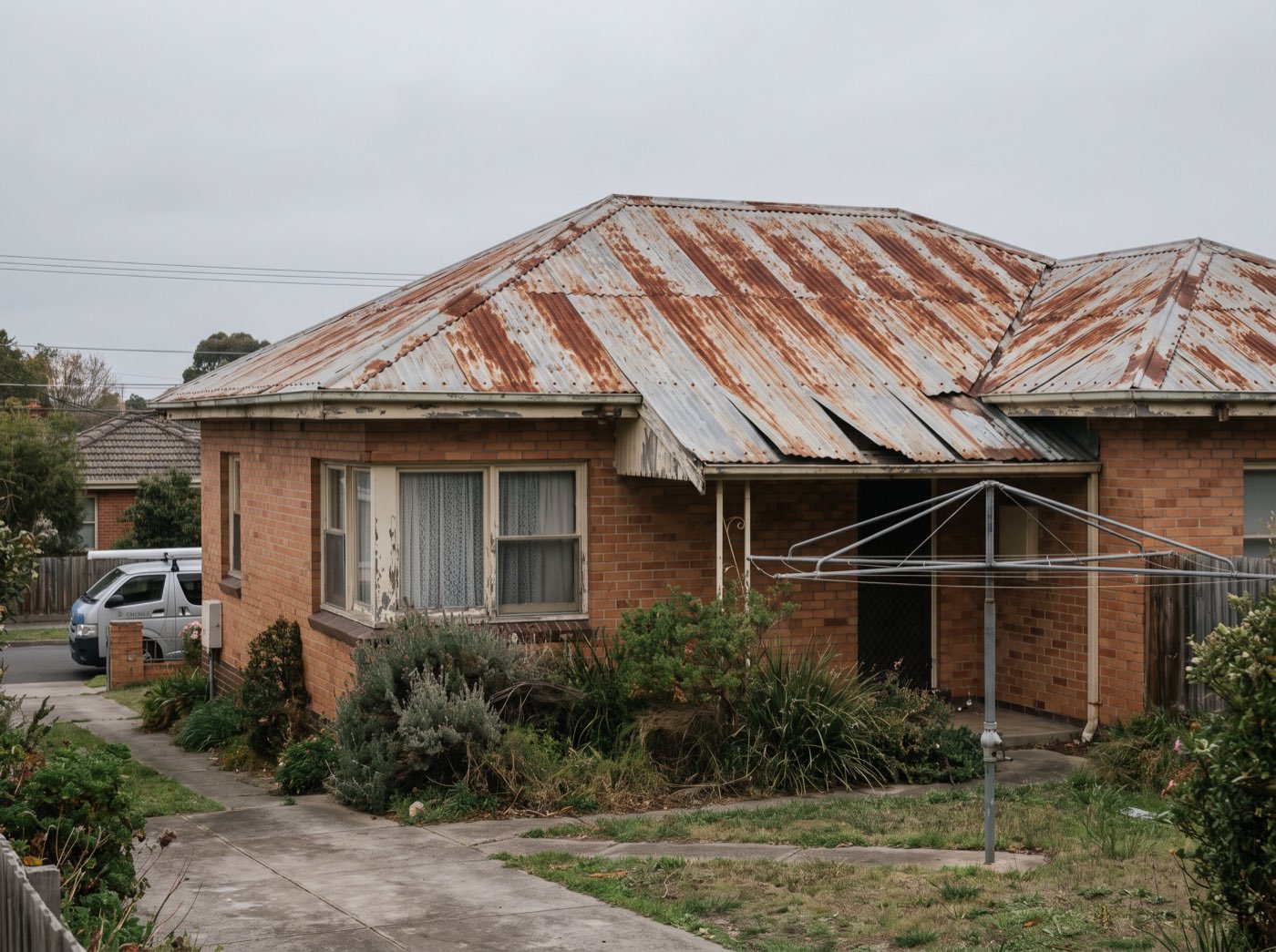 A heavily rusted corrugated metal roof on a Melbourne home