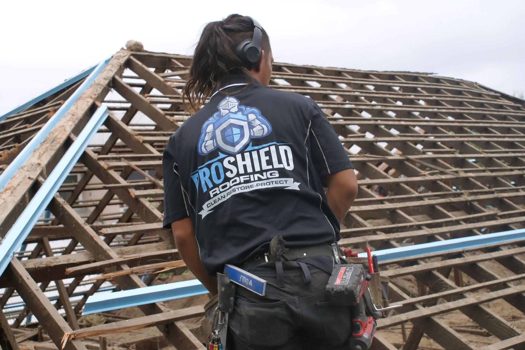 A Pro Shield roofer looking over a roof stripped back to the frame